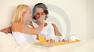 Couple enjoying their breakfast in bed