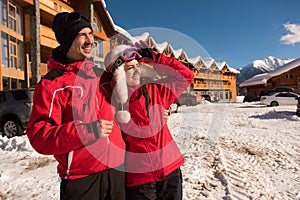 Couple enjoying view of cottages and chalets in a ski resort