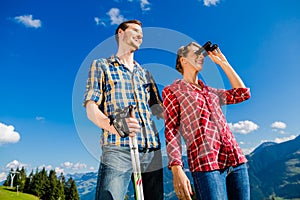 Couple enjoying view hiking in the alpine mountains