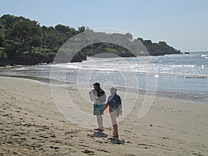 A couple enjoying a walk on the beach