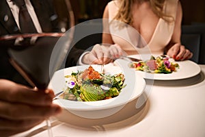 Couple enjoys a delicious dinner in a cozy restaurant