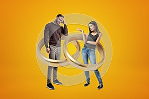 Couple in an entangled gold ring illusion