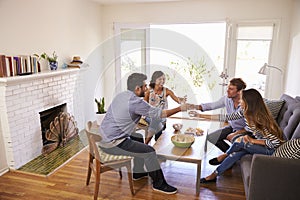 Couple Entertaining Friends At Home