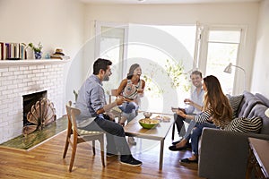 Couple Entertaining Friends At Home