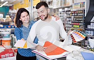 Couple examining various decorative materials