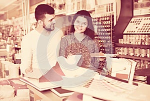 Couple examining various decorative materials