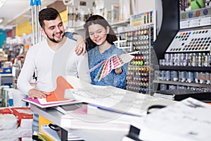 Couple examining various decorative materials