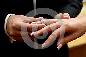 Couple exchanges rings during wedding ceremony.