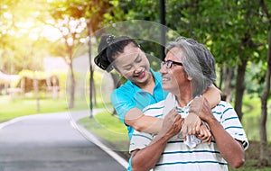 Couple exercise concept. Elderly man and woman relax after exercising together in the public park. Happy smile senior women