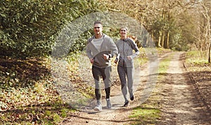 Couple Exercising In Autumn Countryside During Covid 19 Lockdown