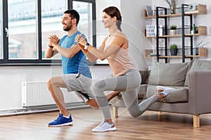 Couple exercising and doing lunge at home