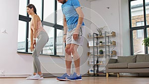 Couple exercising and doing lunge at home