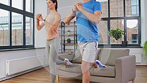 Couple exercising and doing lunge at home