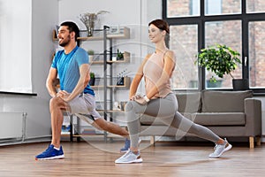 Couple exercising and doing lunge at home
