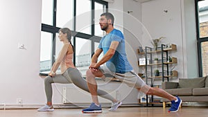 Couple exercising and doing lunge at home