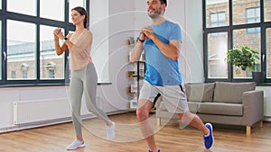 Couple exercising and doing lunge at home