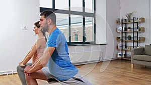 Couple exercising and doing lunge at home