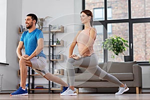 Couple exercising and doing lunge at home