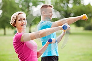 Couple exercising with dumbbells