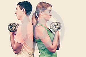 Couple exercising with dumbbells lifting weights