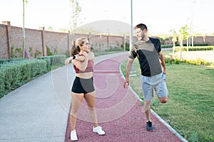 Couple Exercising Together In Park