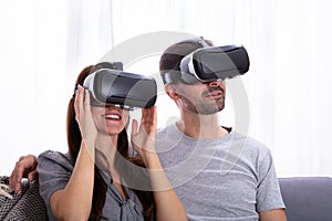 Couple experiencing virtual reality headset photo