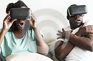 Couple experiencing virtual reality with VR headset photo