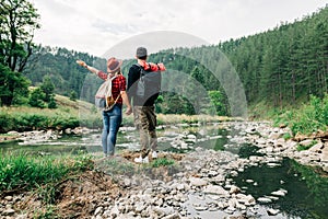 Couple exploring nature by the mountain river