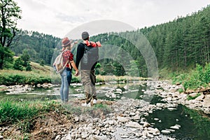 Couple exploring nature by the mountain river