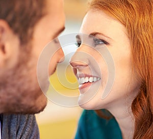 Couple, eye contact and smile with romantic date together in cafe for support, love and bonding. Partner, relax and face