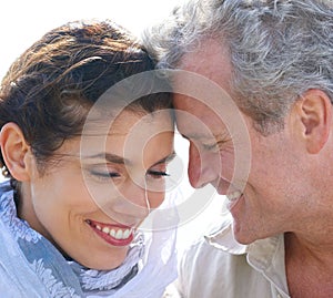 Couple, face and smile outdoor with hug for romance, love and relationship in nature with comfort. Mature, man and woman
