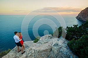 Couple family traveling together on cliff edge in Norway man and woman lifestyle concept summer vacations outdoor aerial