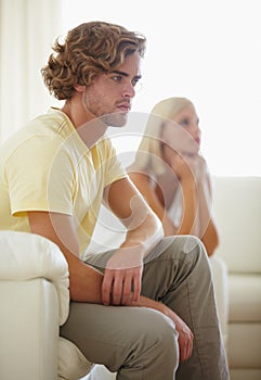 Couple fight, angry and divorce stress on a sofa with argument, anxiety or cheating depression in their home. Marriage