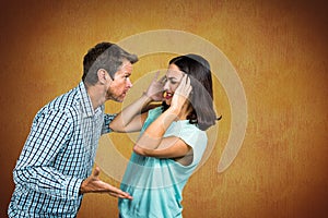 Couple fighting against yellow background