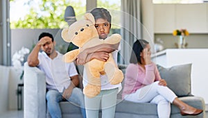 Couple, fighting and sad in child home, living room and girl with teddy bear for support and comfort in family conflict