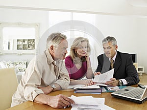 Couple With Financial Advisor At Table