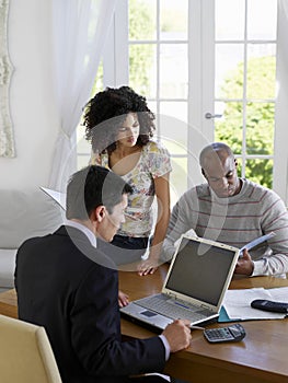 Couple With Financial Advisor At Table