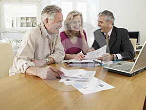 Couple With Financial Advisor At Table