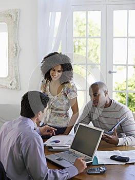 Couple With Financial Advisor At Table