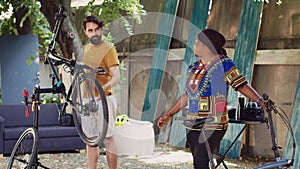 Couple fixing bicycles home yard
