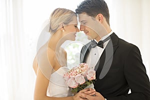 Couple With Flower Bouquet Rubbing Noses