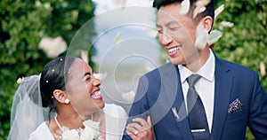 Couple, flower confetti and wedding event with walk, outdoor or happy laugh in nature. Woman, man and excited