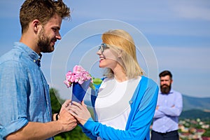Couple with flowers bouquet romantic date. New love. Couple in love dating outdoor sunny day, sky background. Ex husband