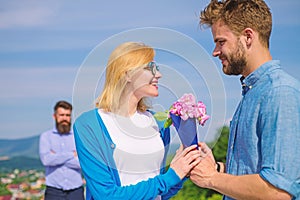 Couple with flowers bouquet romantic date. New love. Couple in love dating outdoor sunny day, sky background. Ex husband