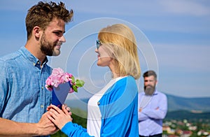 Couple with flowers bouquet romantic date. New love. Couple in love dating outdoor sunny day, sky background. Ex partner