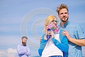 Couple with flowers bouquet romantic date. New love. Ex partner watching girl starts happy love relations. Ex husband