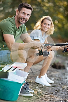 Couple fly fishing in river during summer vacation