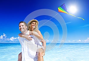 Couple Flying a Kite on the Beach Vacations Concept