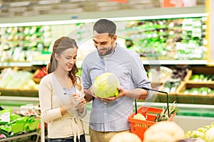 Couple with food basket shopping at grocery store