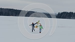 Couple is fooling around on a snow-covered field. 